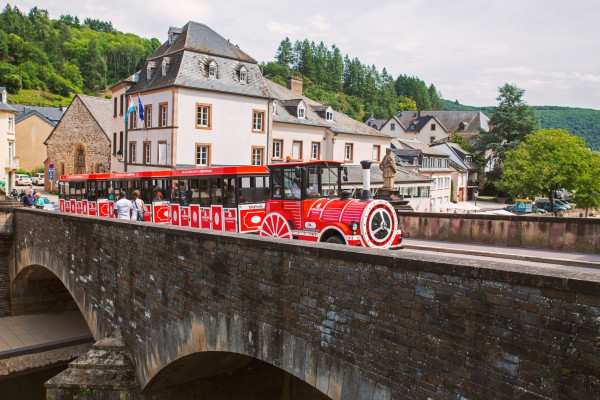 Vianden Express while crossing the medieval bridge in Vianden