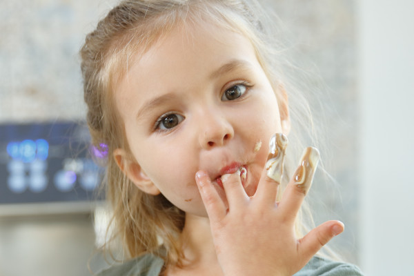 Child licking her fingers
