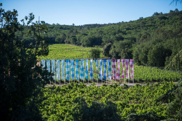 The "Damier flottant arc-en-ciel" by Daniel Buren in the vines of the vineyard Château Peyrassol