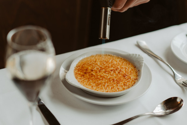 Crème brûlée flambé at the table.