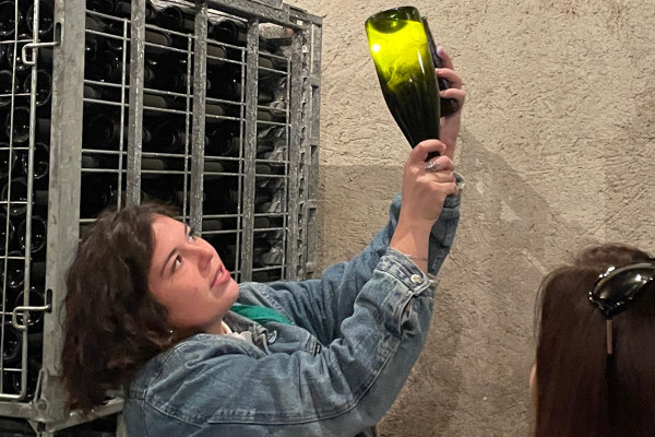 Héloïse showing the yeast in an aged bottle of champagne in the cellar.
