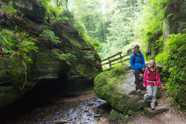 A young couple trekking in Mullerthal, sightseeing.lu