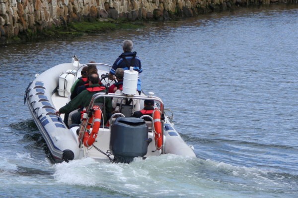 Trainees studying safety procedures and emergency protocols on high-speed vessels as part of their comprehensive RYA Powerboat Level 2 certification program.