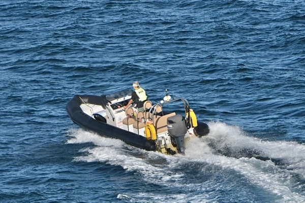 A group of enthusiastic trainees steering speedboats in perfect unison, honing their powerboating skills during an RYA Powerboat Level 2 course.