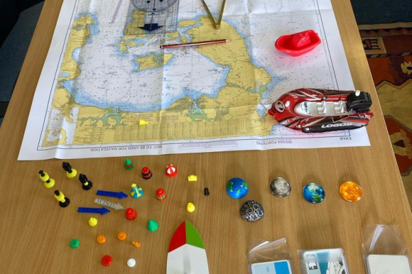 A well-equipped and interactive classroom setting hosting an engaging RYA Powerboat Course, where participants are immersed in theoretical sessions, learning about navigation, safety regulations, and advanced powerboat techniques.