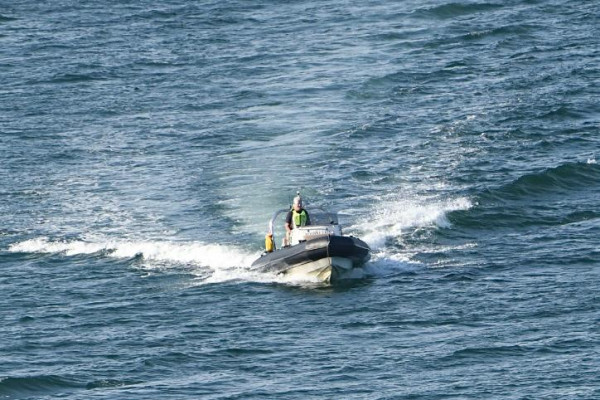 Trainees studying safety procedures and emergency protocols on high-speed vessels as part of their comprehensive RYA Powerboat Level 2 certification program.