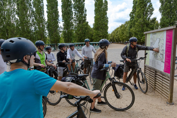 inaeri e-bike tour group stopped in versailles palace parc