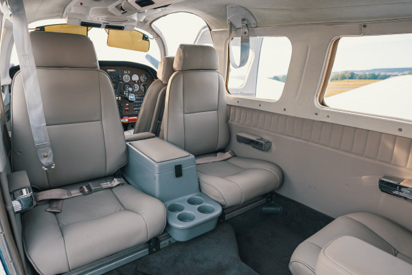 Interior of the aircraft bi engine, the 4 seats back seat in light gray leather.