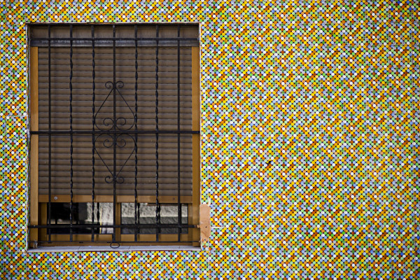 Detailed close-up of hand-painted ceramic tiles adorning a house in Valencia’s iconic seaside neighborhood.