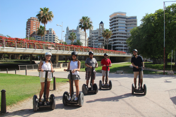 Group of tourists are riding on Segways in Turia Park during the guided tour from cruise terminal