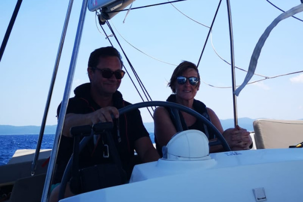 skippers at the helm of a catamaran