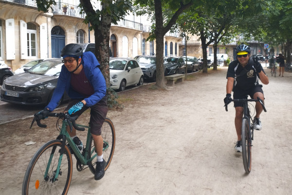 Cyclists riding through the Jardin Public on a guided gravel bike tour.