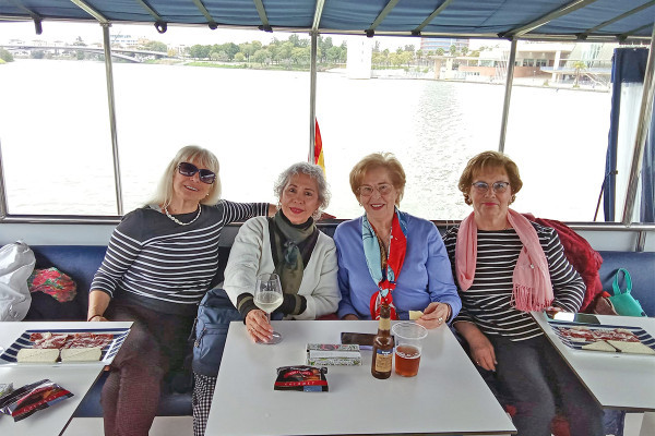 Enjoying a river cruise with tapas and views of Seville.