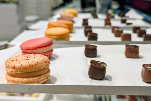 Tasting of macarons from an artisanal bakery during a Food Tour at Les Halles Paul Bocuse