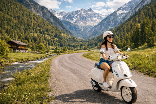 Girl on a Vespa driving through a Valley