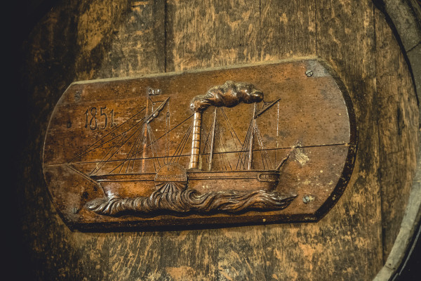 Bodega Mallorca einzigartiges Verkostungserlebnis. Nahaufnahme eines jahrhundertealten Fasses, ausgerichtet im Keller des Weinguts und der Brennerei, die 1851 auf Mallorca gegründet wurde. Entdecken Sie einen historischen unterirdischen Keller.