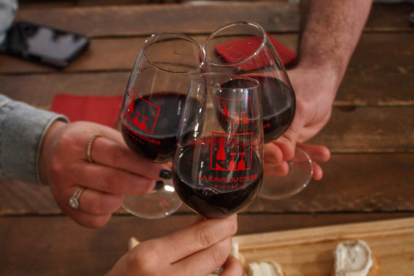 Trois personnes partagent une dégustation d'un vin rouge de Provence.